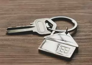 Keys on a key chain with a house on it to symbolize home ownership