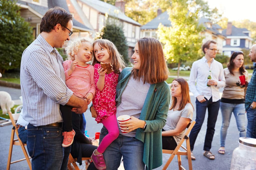 Parents with children gathered for a community block party.