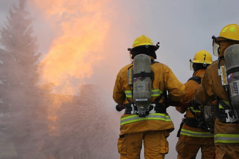 Firefighters in training to put out an active fire.