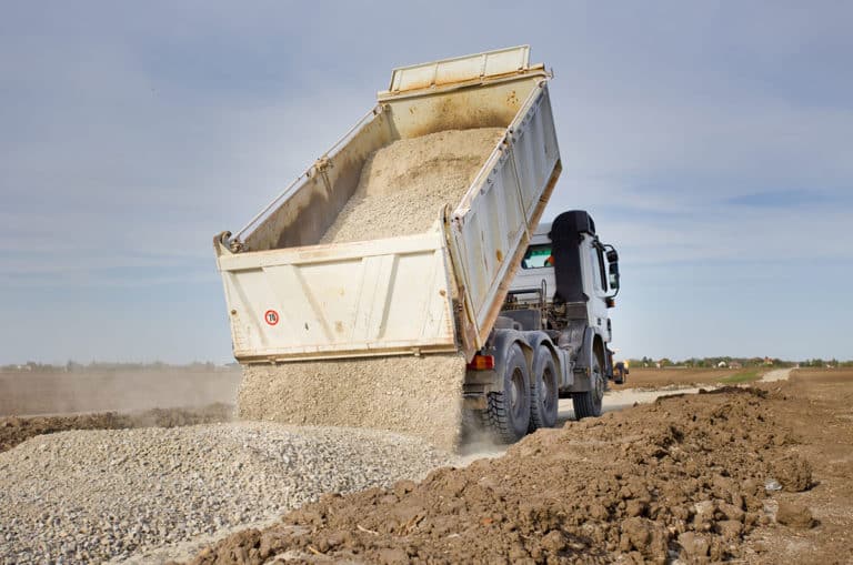 Gravel truck dumping gravel.