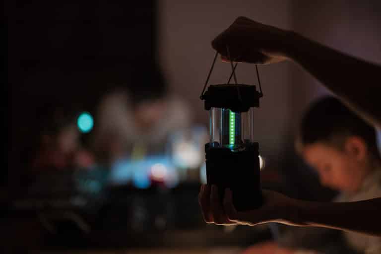 Family using an LED lantern due to a power outage