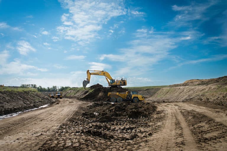 An excavator working at a sand and gravel extraction pit.