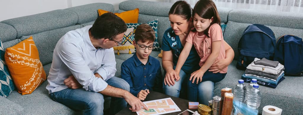 Family working together to create emergency plan.