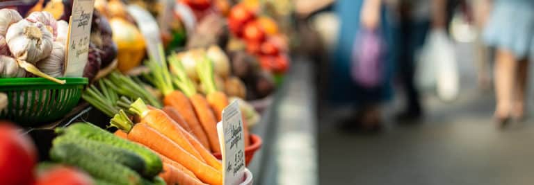 Fresh vegetables shown on a table at a market.