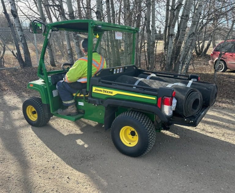 Green utility vehicle with a driver